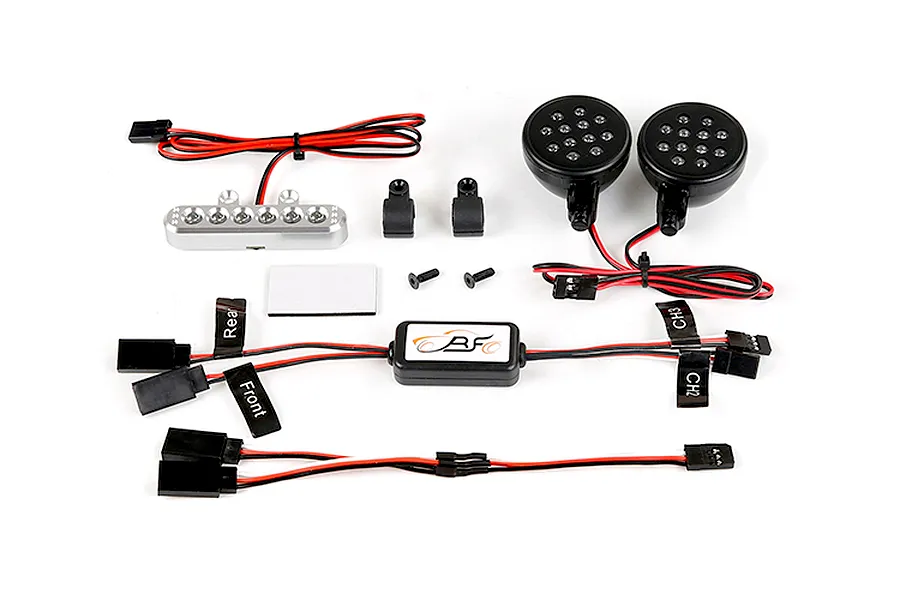 Rovan RC light controller kit including a silver rear light bar, two round front LED lamps, a control module, wiring harnesses, and mounting hardware.