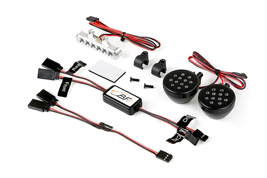 Rovan RC light controller kit including a central control module, two round front LED light pods, one silver rear LED light bar, and wiring harnesses.