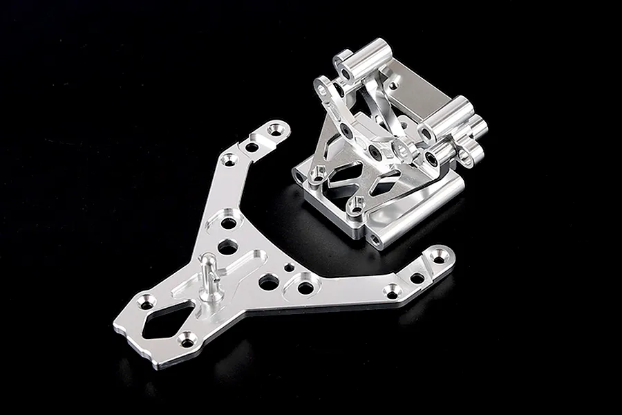 Rovan silver aluminium front bulkhead set including an upper plate for RC vehicles on a black background.