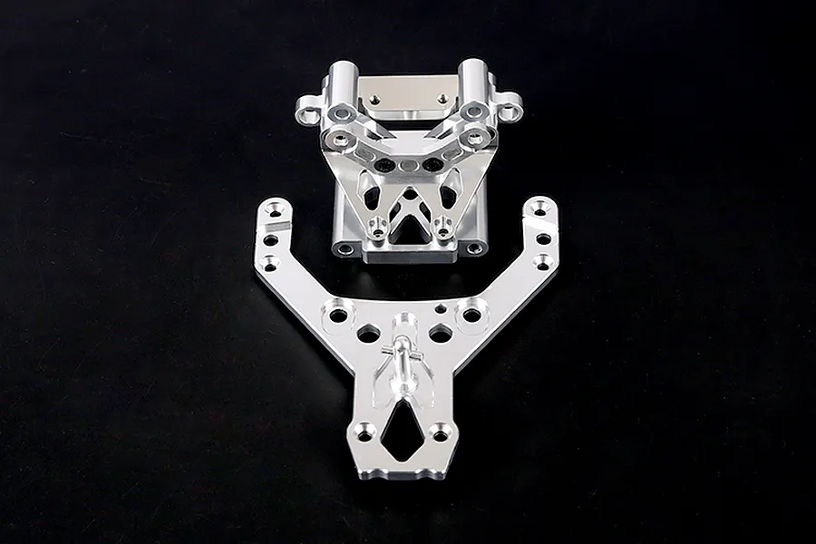 Silver aluminium front bulkhead set with upper plate for Rovan RC vehicles, shown on a dark background.