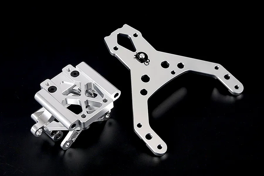 Rovan silver aluminium front bulkhead set with upper plate for RC cars, shown on a black background.