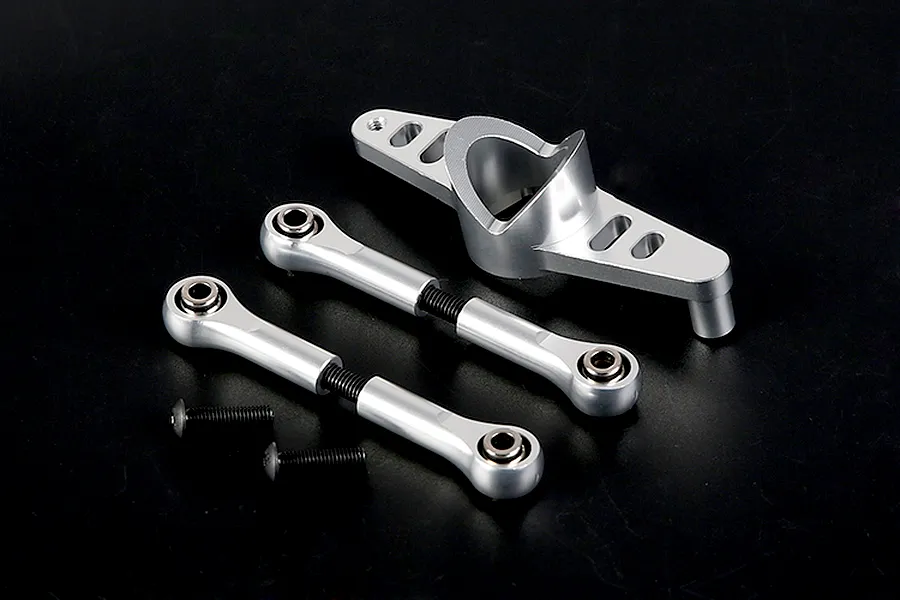 Rovan silver aluminium steering assembly parts including a central mount, two turnbuckle rods with ball ends, and two black screws on a black background.