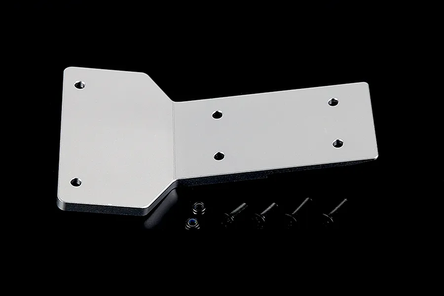A silver aluminium front skid plate for an RC car, shown with four black screws and two small nuts on a dark background.