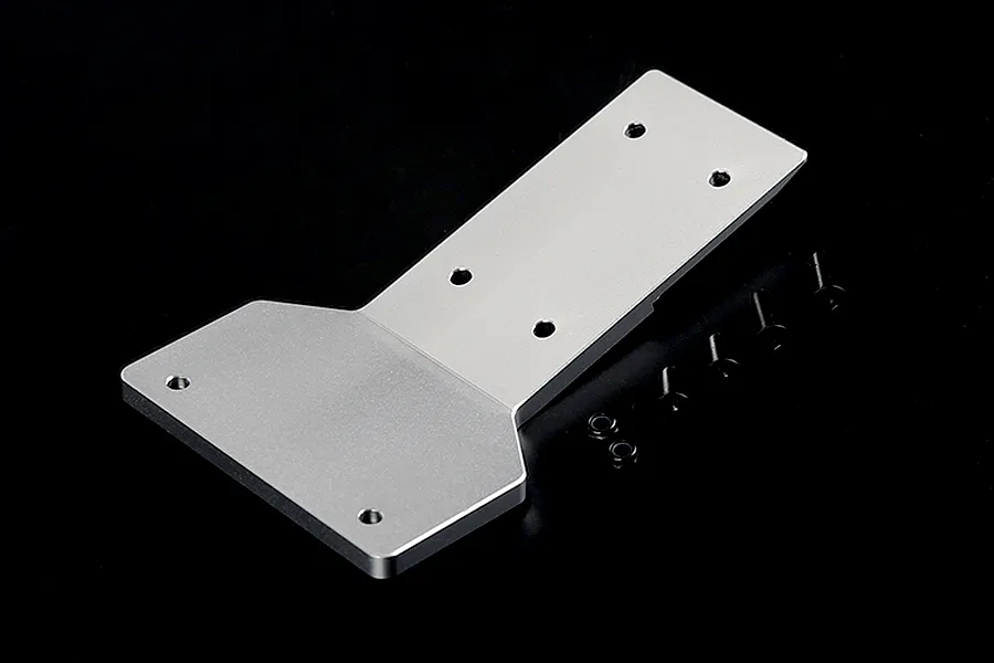 A silver aluminium front skid plate for an RC car, accompanied by four black screws and two black nuts, set against a plain black background.