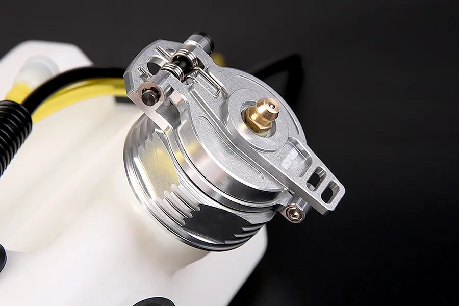 A silver Rovan aluminium fuel tank cap installed on a white plastic RC fuel tank against a dark background.