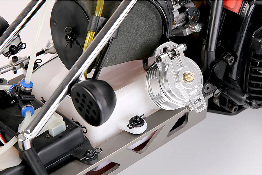 A silver aluminium fuel tank cap installed on a white plastic fuel tank of an RC vehicle.
