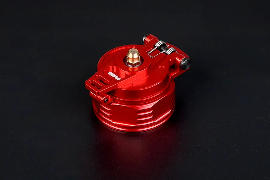 A red anodized aluminium fuel tank cap for RC vehicles featuring a hinged latch mechanism and a brass center fitting.