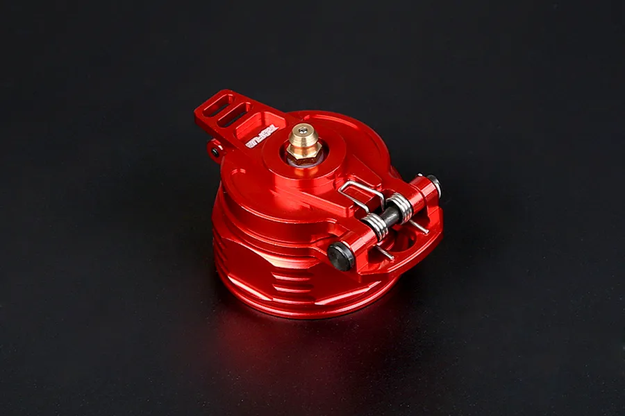 A red anodized aluminium fuel tank cap for RC vehicles, featuring a spring-loaded latch mechanism and a brass-coloured center fitting.