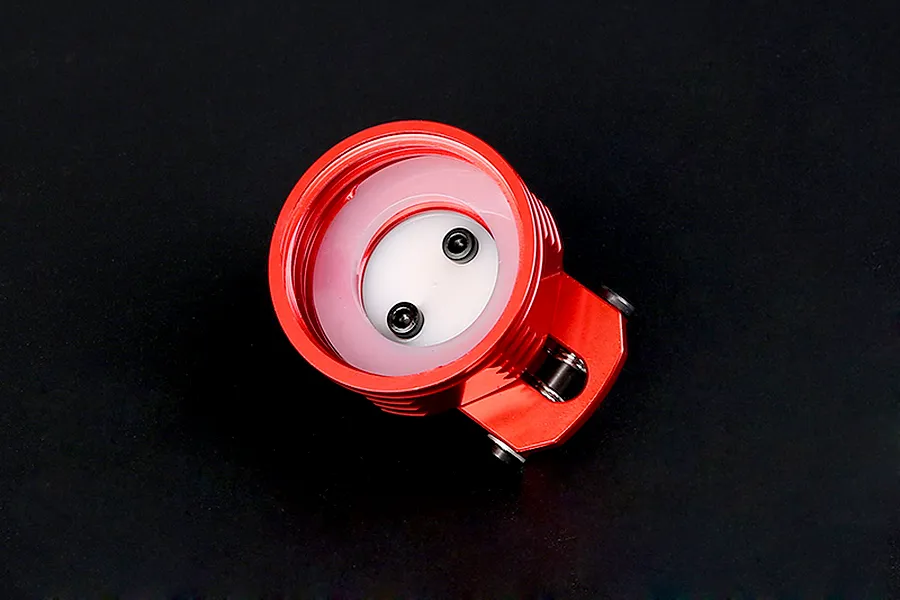 A red anodized aluminium fuel tank cap for RC vehicles, showing the underside with a white silicone seal and two small black screws.