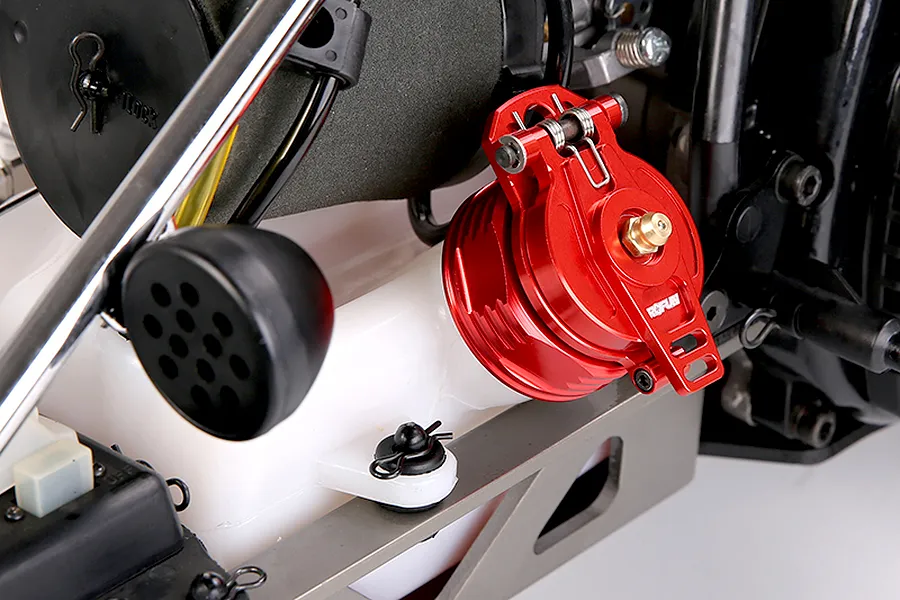 A red Rovan aluminium fuel tank cap installed on a white RC fuel tank, featuring a spring-loaded latch mechanism.