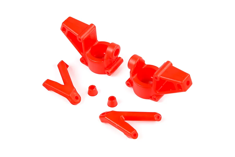A set of red nylon RC steering hubs and associated suspension components on a white background.