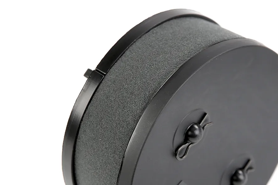 Close-up of a round black RC air filter with foam element and two R-clips on the end cap.