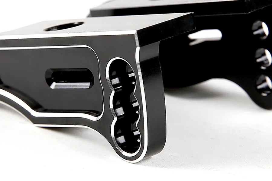 Close-up of black anodized aluminium RC rear wing mounts with silver chamfered edges.