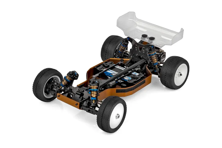High angle studio shot of Team Associated RC10 4WD electric buggy chassis kit featuring carbon fiber shock towers and bronze chassis.