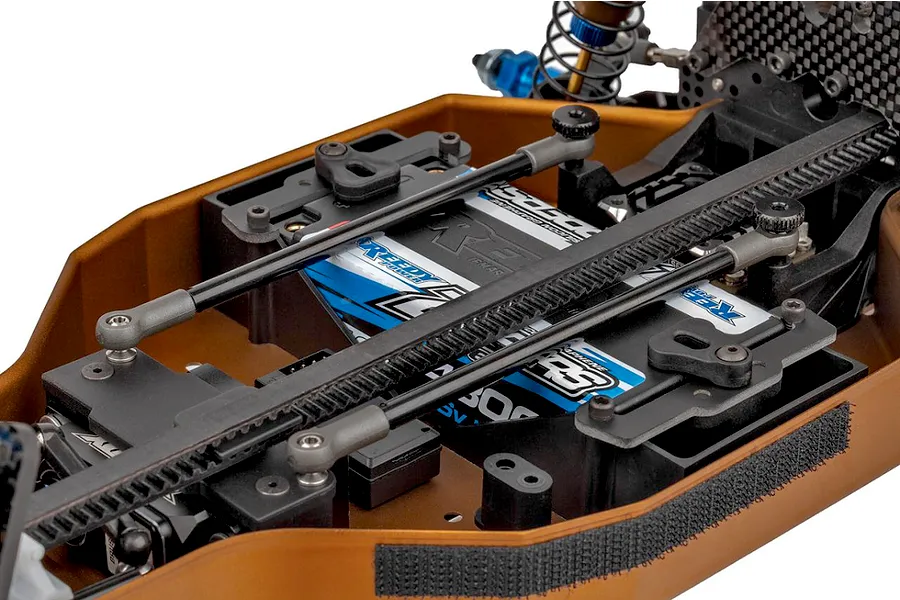Close-up studio view of the chassis layout and electronics compartment of the Team Associated RC10 4WD RC buggy kit.
