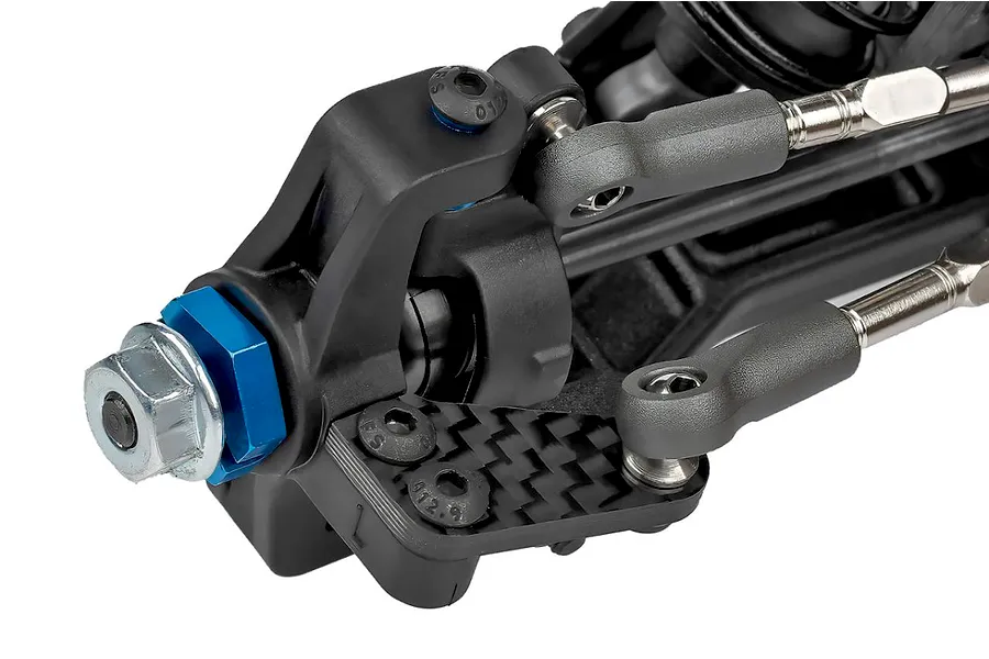 Close-up studio view of an RC car front suspension hub assembly featuring carbon fiber and metal components.