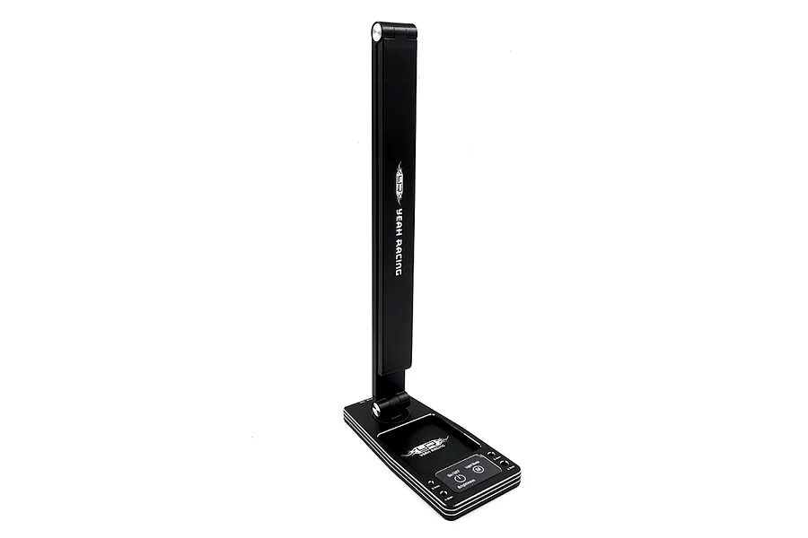 Yeah Racing aluminium LED pit light in black shown folded upright with its integrated parts tray base on a white background.