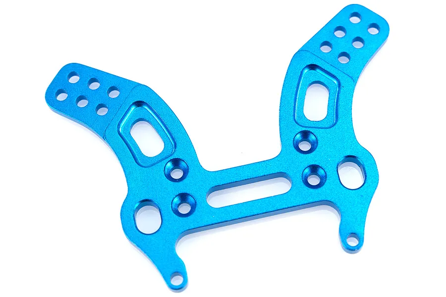 A blue anodised aluminium front shock tower for an RC car, featuring multiple mounting holes and cutouts, isolated on a white background.