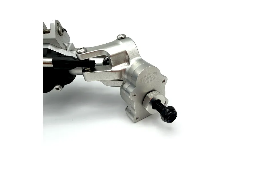 Close-up studio view of the silver aluminium front portal axle assembly for RC vehicles, highlighting metal steering knuckles and hardware.
