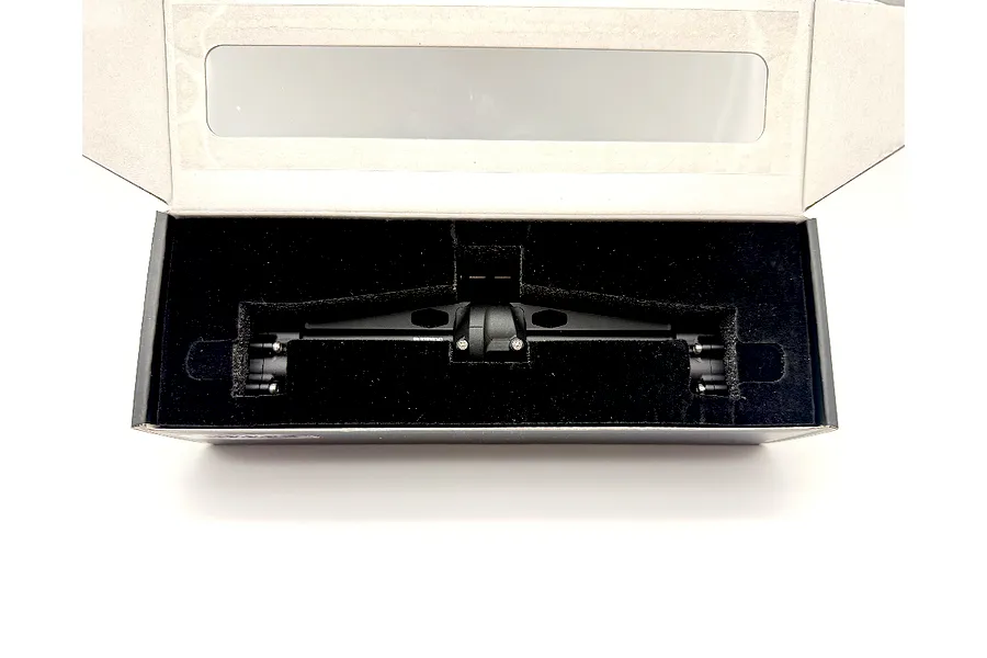 A black metal RC portal axle housed securely inside a custom cutout foam packaging box.