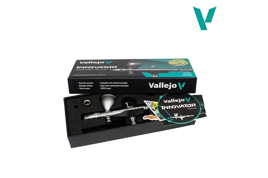 Vallejo Innovator 2-in-1 precision airbrush in its retail box with lid open, showing the silver airbrush, accessories, and branding.