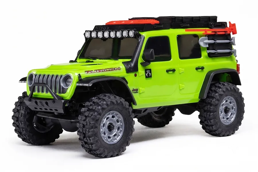 Studio product photo of a bright green Axial Jeep Wrangler RC rock crawler with roof rack and accessories on a white background.