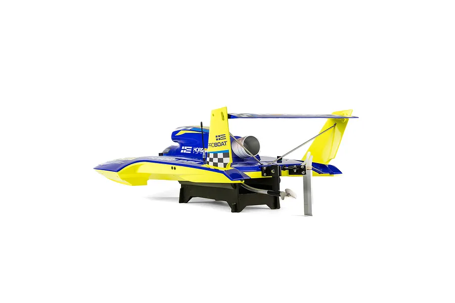 Rear-quarter view of the Pro Boat Miss Illinois U-34 RC boat on a stand against a white background, highlighting its blue and yellow livery, large rear wing, propeller, and rudder.
