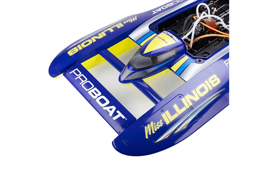 Top-down view of the Pro Boat Miss Illinois U-34 RC boat deck, showing the blue hull with yellow and silver graphics and open cockpit compartment with motor.