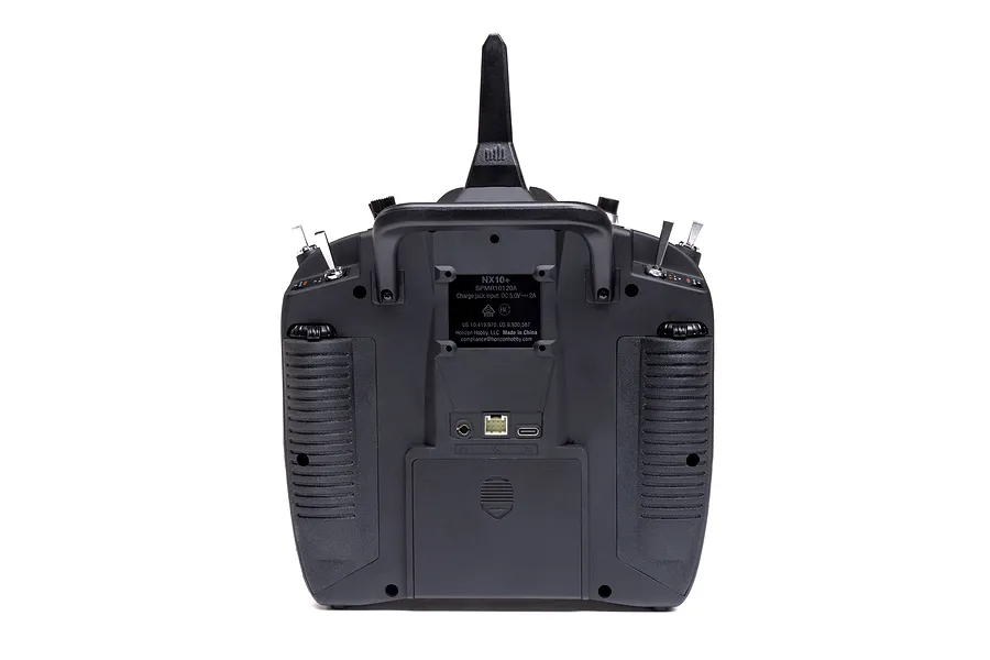 Rear view of the Spektrum NX10+ 20ch DSMX transmitter, showing ports, battery compartment, and switches on a white background.