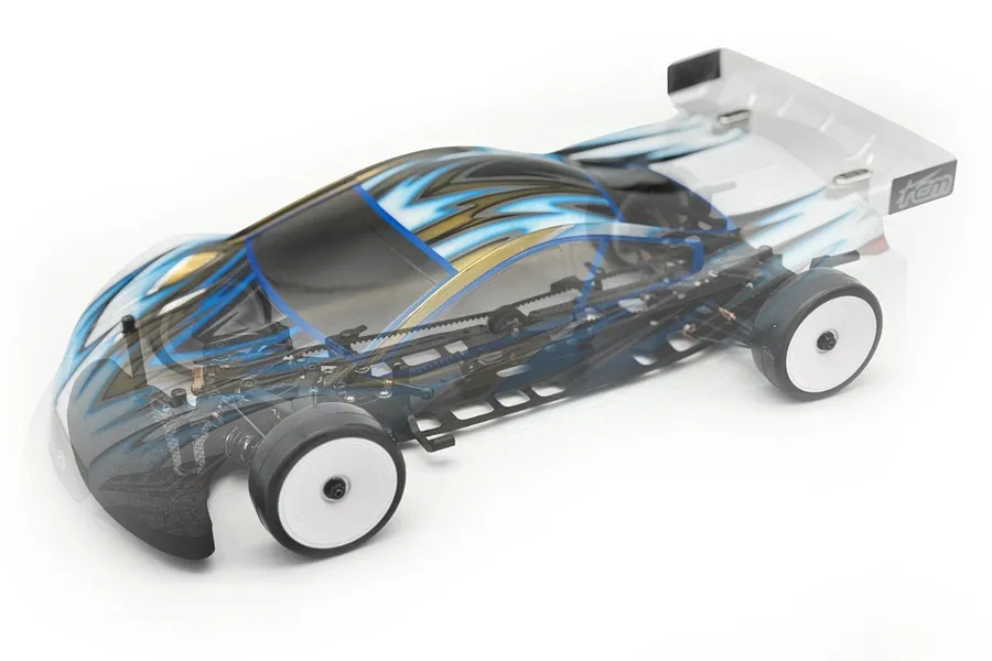 RC Maker SP2 EP 1/10 electric touring car kit showing internal chassis components beneath a translucent painted body shell.