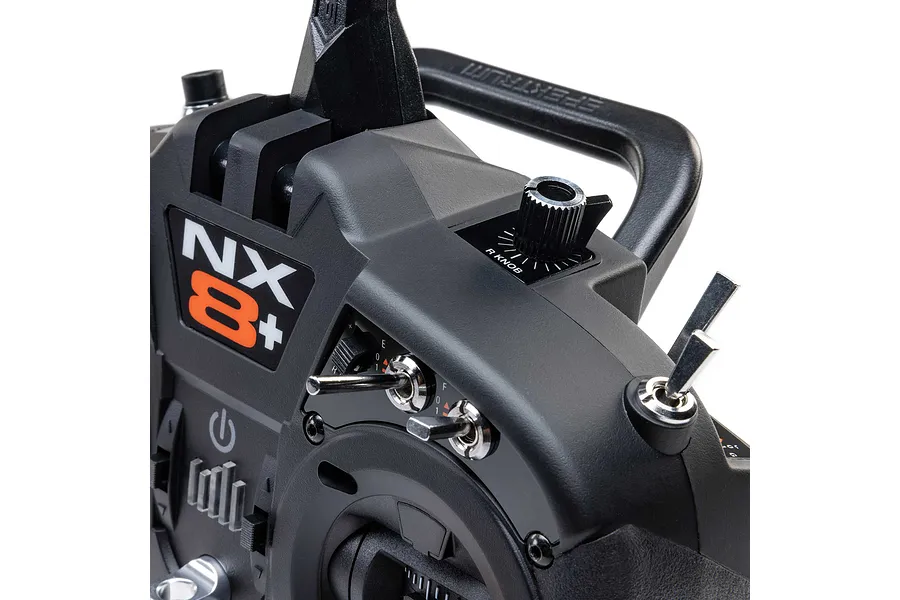Close-up view of the Spektrum NX8+ transmitter showing switches, dials, and the NX8+ logo.