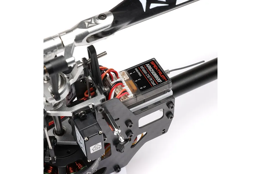 Close-up of the internal electronics and Spektrum flight controller mounted on the Blade InFusion 210 RC helicopter frame.