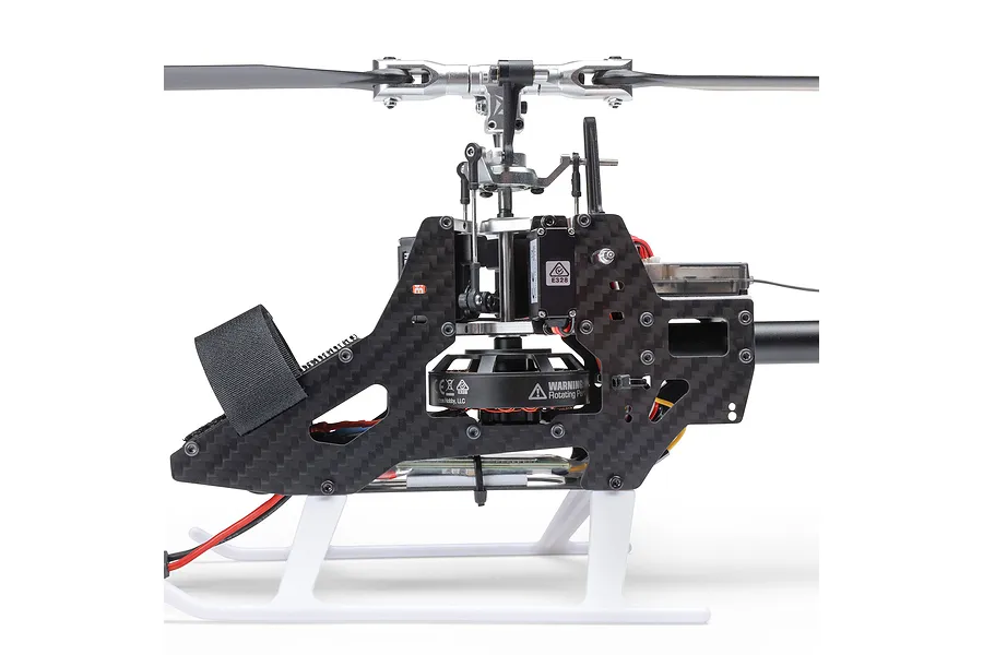 Close-up side view of the Blade InFusion 210 RC helicopter main frame, rotor head, electronics, and motor against a white background.