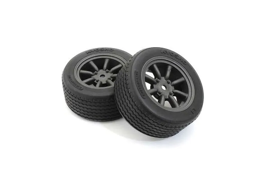 Two black RC street tyres mounted on dark 8-spoke wheels against a clean white background.