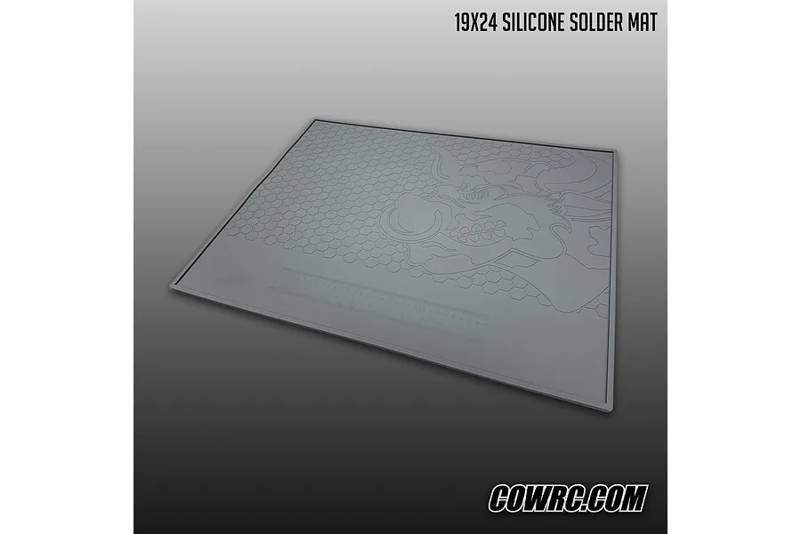 CowRC 19x24 Silicone Solder Mat shown laid flat with a bull logo and built-in ruler against a gradient background.
