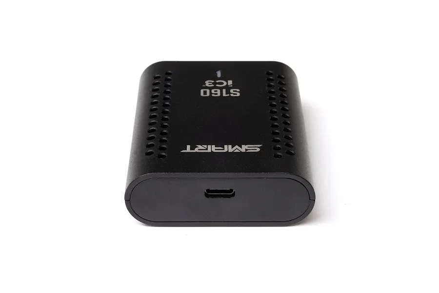 Spektrum S160 smart charger shown from an angle, highlighting its black plastic housing, cooling vents, and USB-C port.