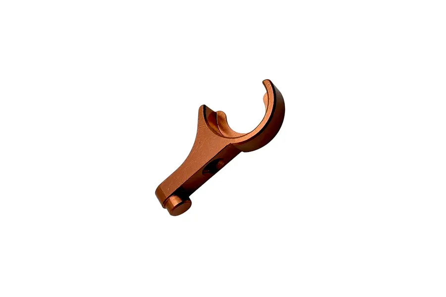 An orange anodized aluminum anti-roll bar holder isolated on a plain white background.