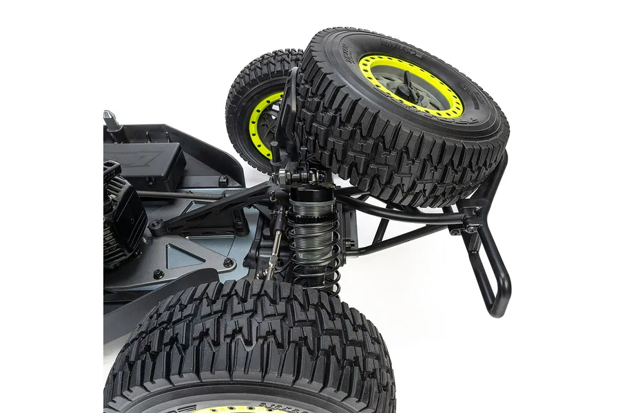 Close-up of the rear suspension, coil-over shock, and large treaded tires on a Losi RC short course truck.