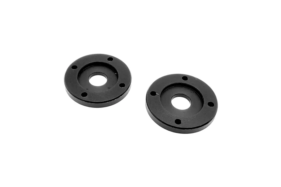 Two black RC Maker 4-hole shock pistons viewed from above against a clean white background.
