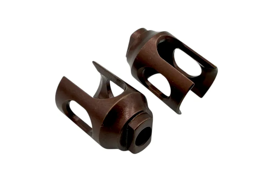 Two brown metal RC outdrive cups against a plain white background, showing their slotted and socketed design.