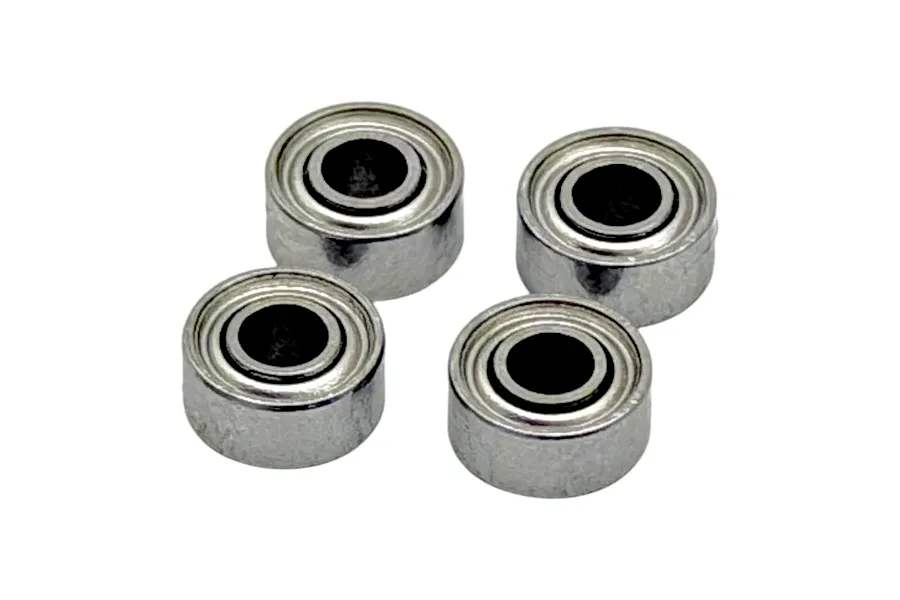 Four small metal shielded ball bearings arranged on a plain white background.