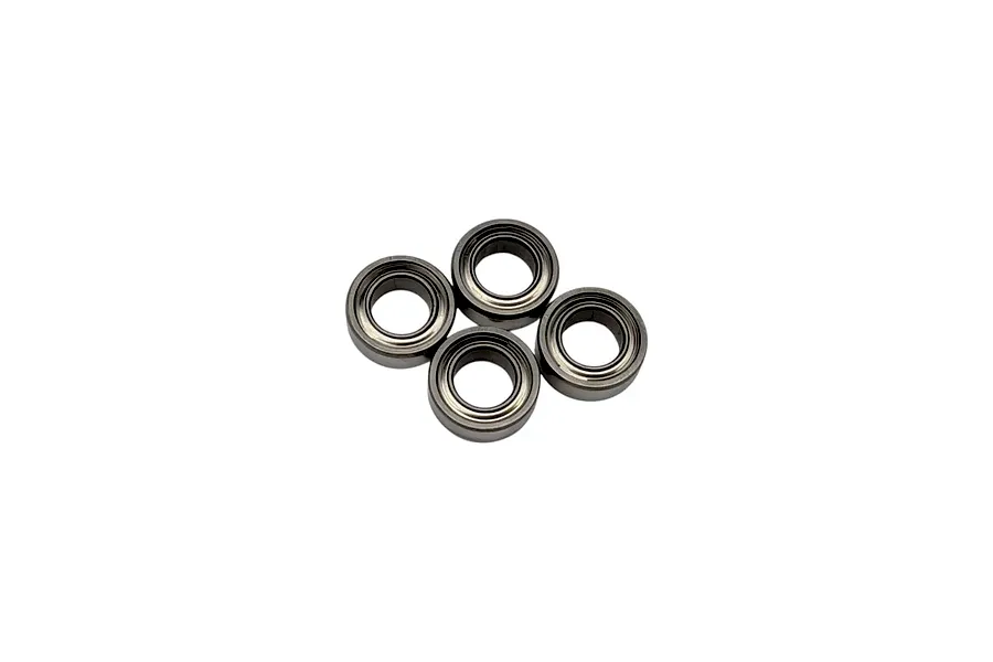 Four metal shielded RC hobby bearings arranged in a cluster against a plain white background.