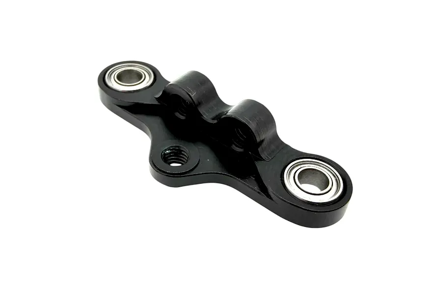 RC Maker black anodised aluminium steering rack with pre-installed metal shielded bearings on a white background.