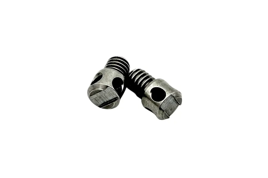 Close-up studio shot of two small metal RC Maker anti-roll bar adaptor shafts with threaded ends and slotted screw heads against a white background.