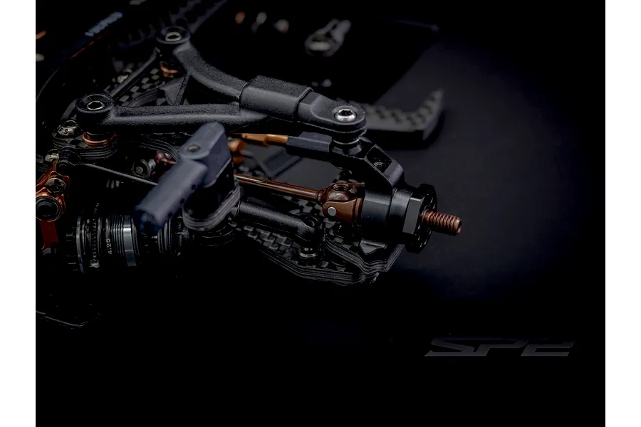 Close-up of the front suspension and universal driveshaft on an RC Maker SP2 EP RC touring car kit.