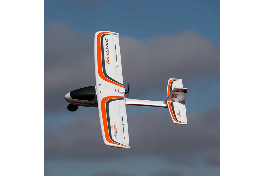 HobbyZone AeroScout S 2 RC trainer airplane flying in a clear blue sky with light clouds.