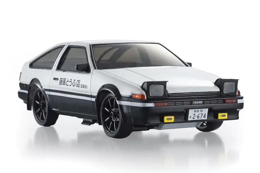 Kyosho First Mini-Z Initial D Toyota Trueno AE86 RC car studio shot in white and black with pop-up headlights.