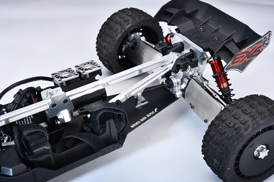 GPM aluminium rear chassis brace installed on an RC model vehicle chassis against a white background.