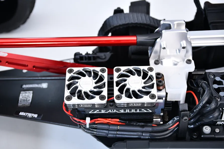 Two black and silver GPM cooling fans installed on a model RC car chassis motor mount.