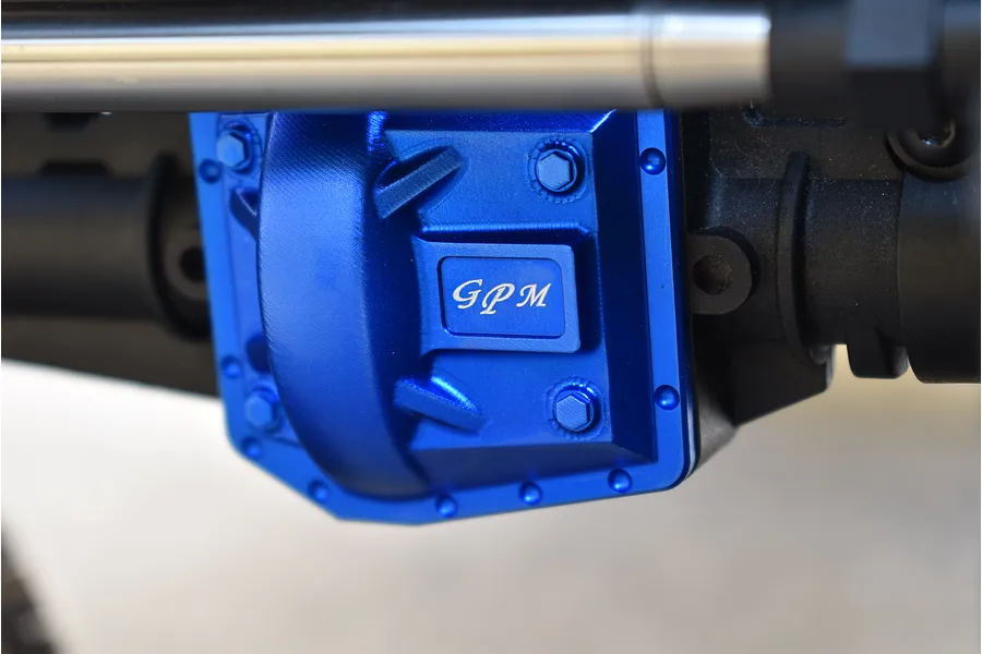 Close-up of a blue anodized aluminium GPM differential cover installed on an RC vehicle axle housing.